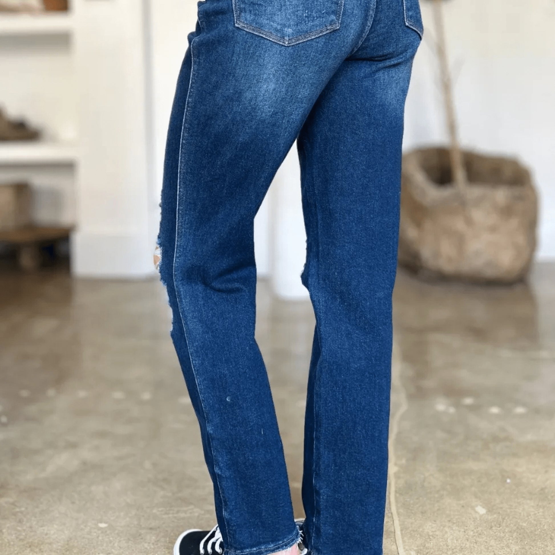 Back view of high-waist straight jeans showing fit and pockets.