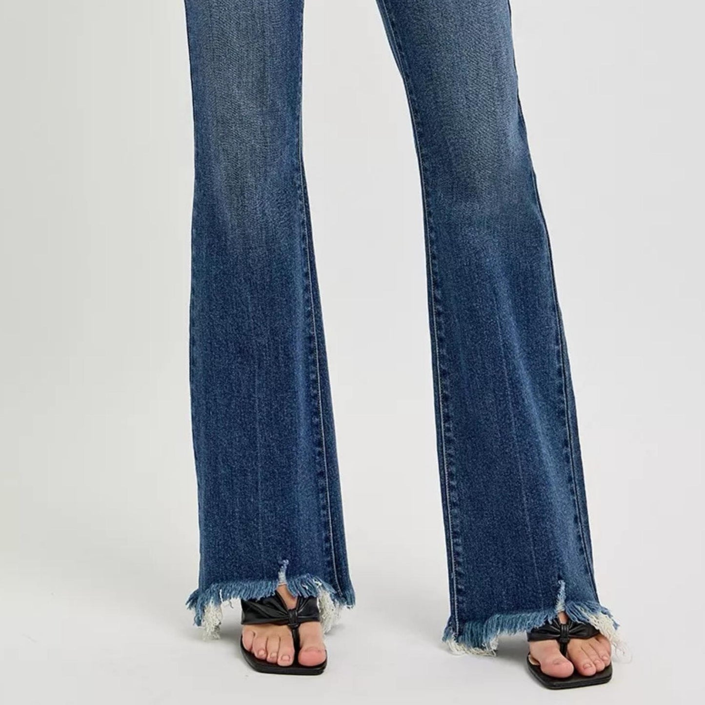 Close-up of the dark wash denim texture and stitching on RISEN jeans.