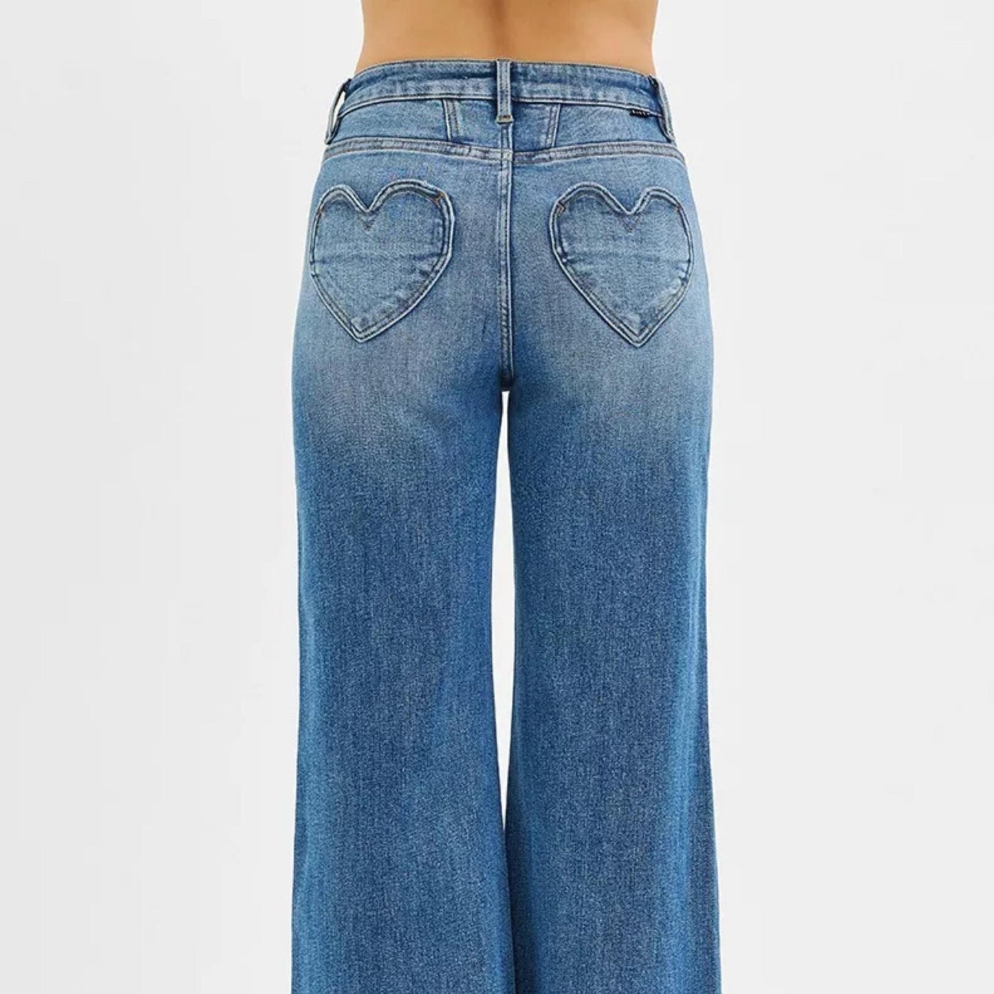 Back view of RISEN wide-leg jeans highlighting the heart-shaped pockets.