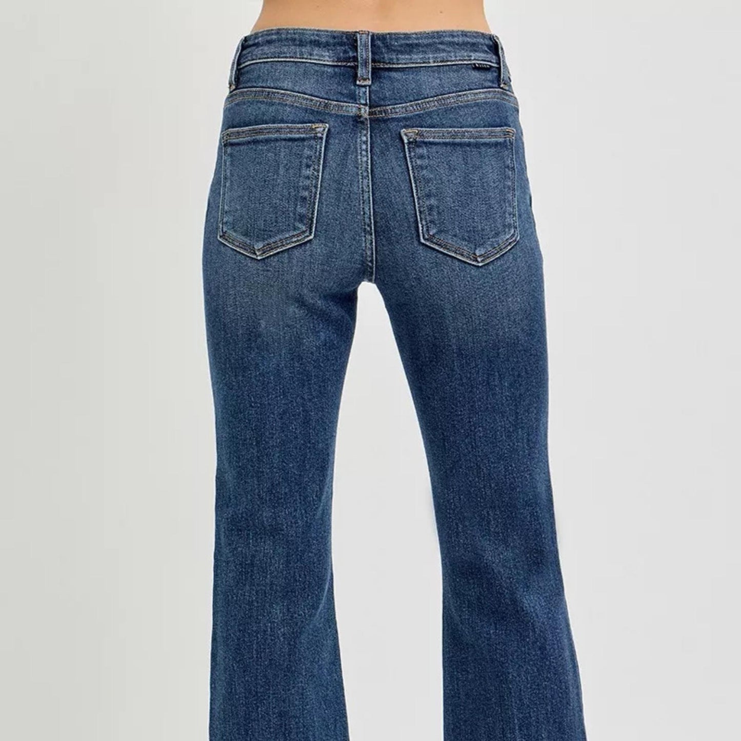Back view of RISEN dark wash flare jeans showing pocket placement.