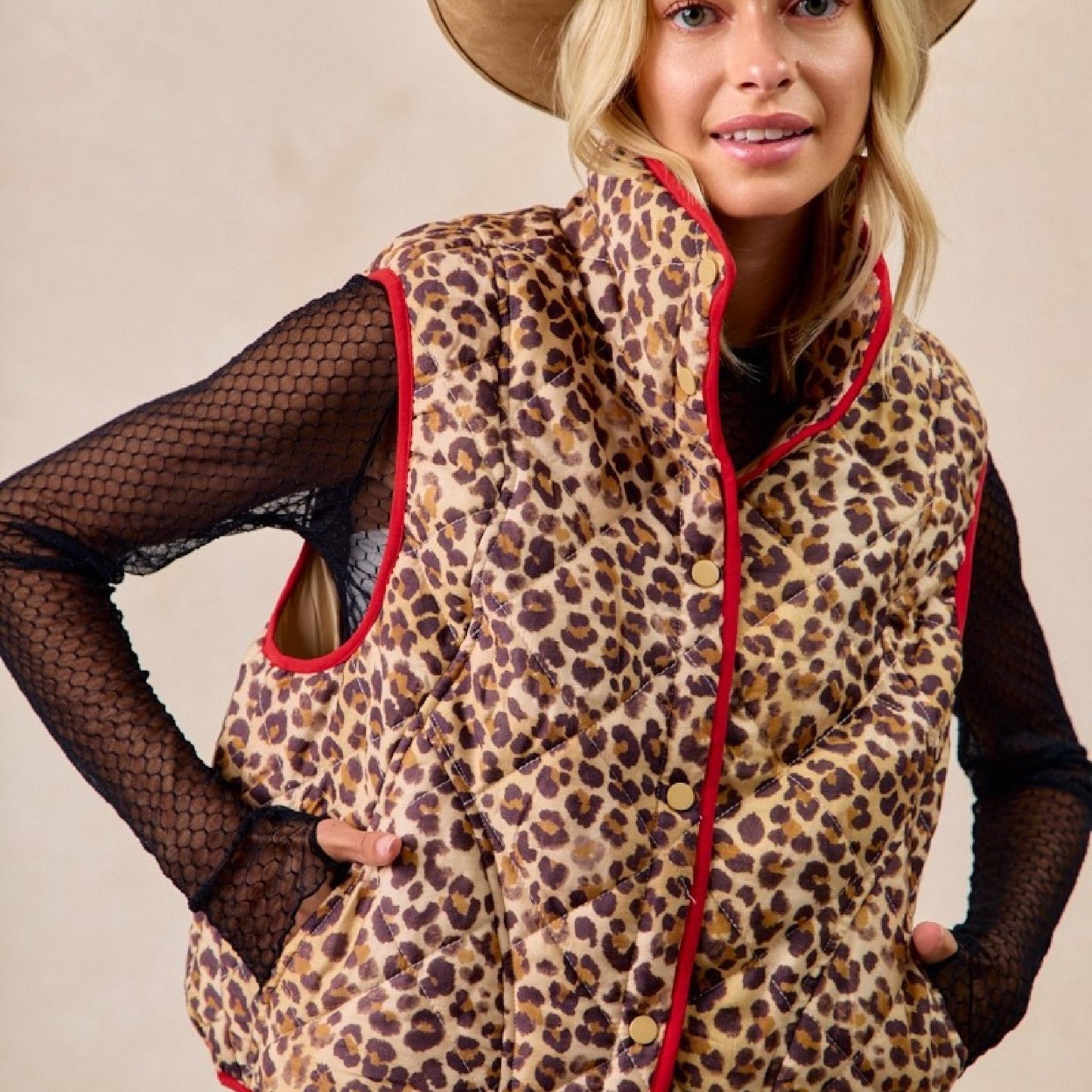 Front view of a woman wearing the neutral Bibi leopard print quilted vest