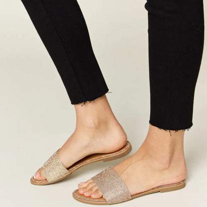 Back view of the rose gold low-profile heel and secure slip-on design.