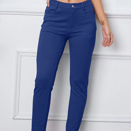 Royal Blue pants worn by a person against a white wall