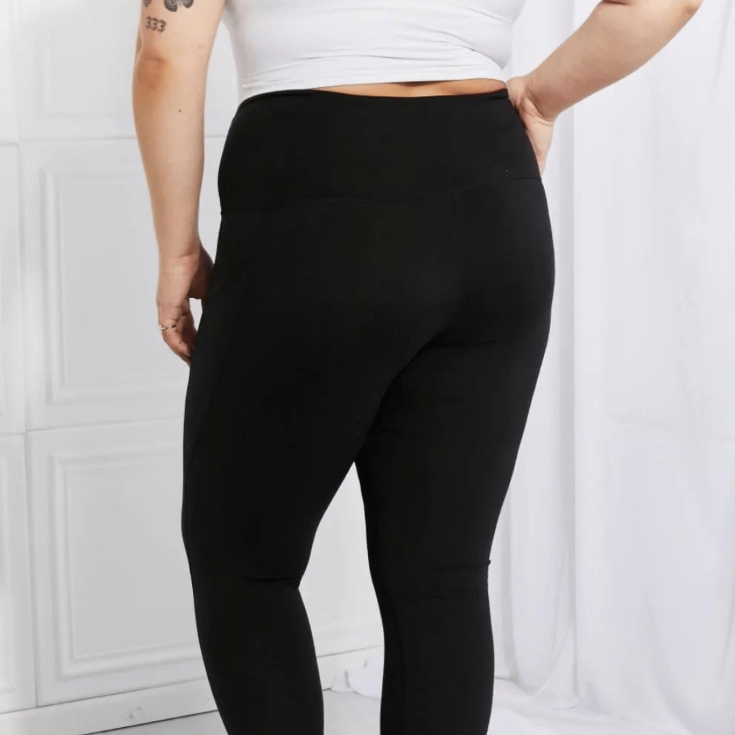 Close-up shot of the reflective safety dots on black performance workout leggings.