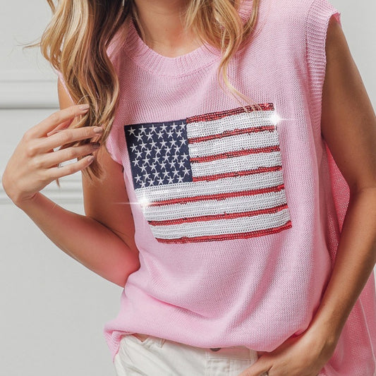 Person wearing a pink sleeveless top with an American flag design.