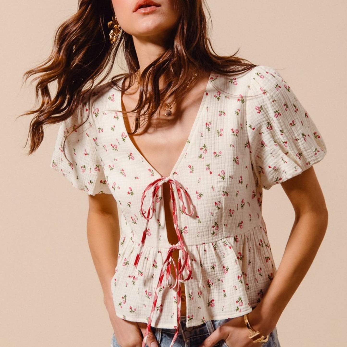 Side profile of the tie-front boho blouse in ivory red, highlighting the ruffled sleeves and comfortable fit.