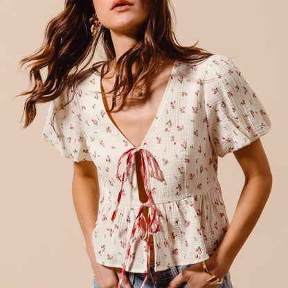 Side profile of the tie-front boho blouse in ivory red, highlighting the ruffled sleeves and comfortable fit.