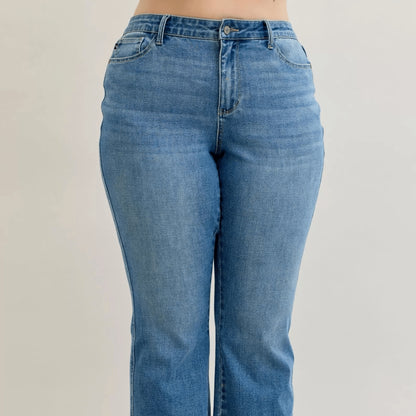 Detail view of the mid-rise waist and slim bootcut leg on Judy Blue jeans.