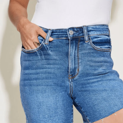 Detailed shot of high-waist slim shorts in medium wash.