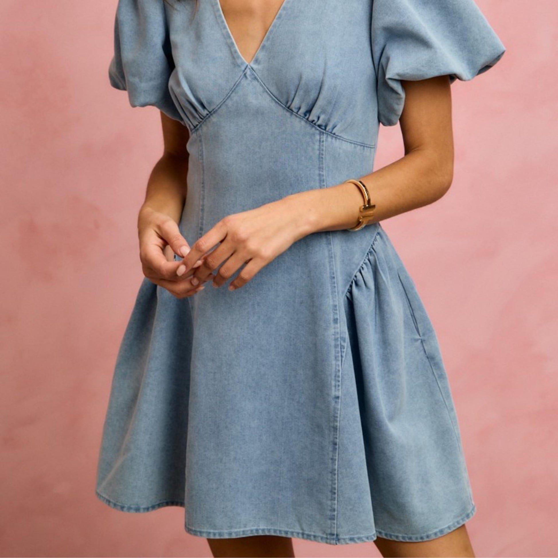 Full-length view of the SO ME light wash puff sleeve denim mini dress.