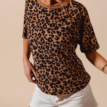 Side profile of the SO ME leopard print waffle knit top highlighting the relaxed fit.