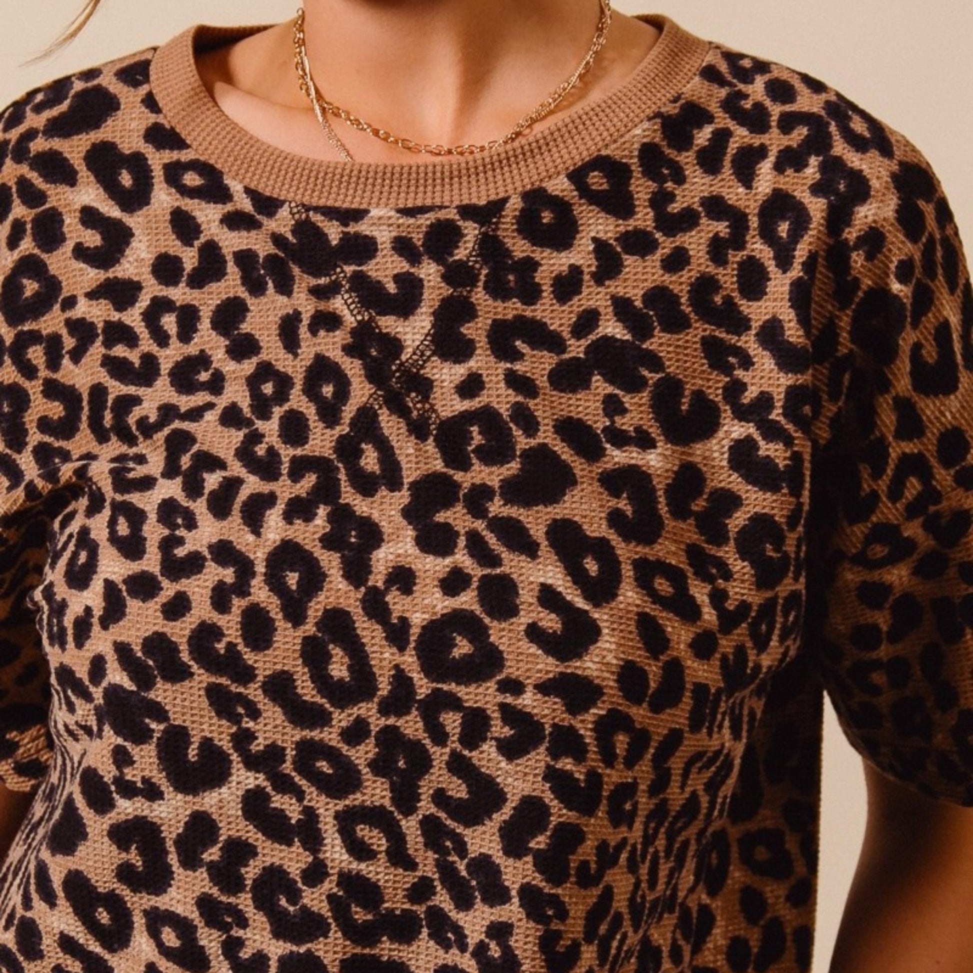 Casual outfit view of the loose-fit SO ME leopard thermal top.