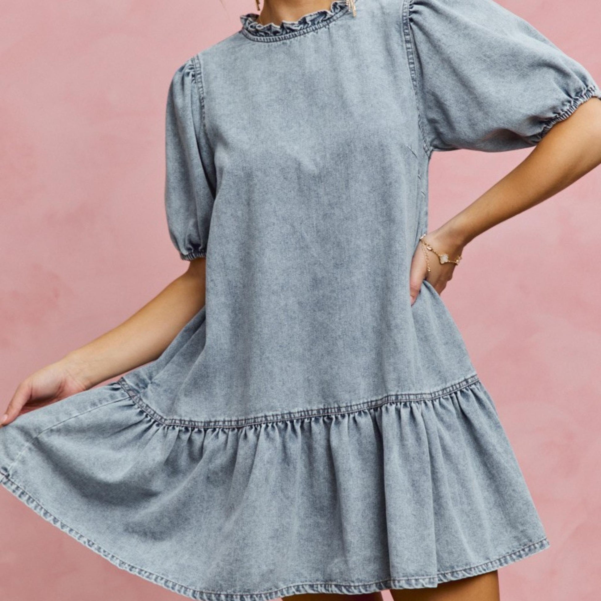Detailed view of the tiered ruffle hem on the light wash SO ME denim dress.
