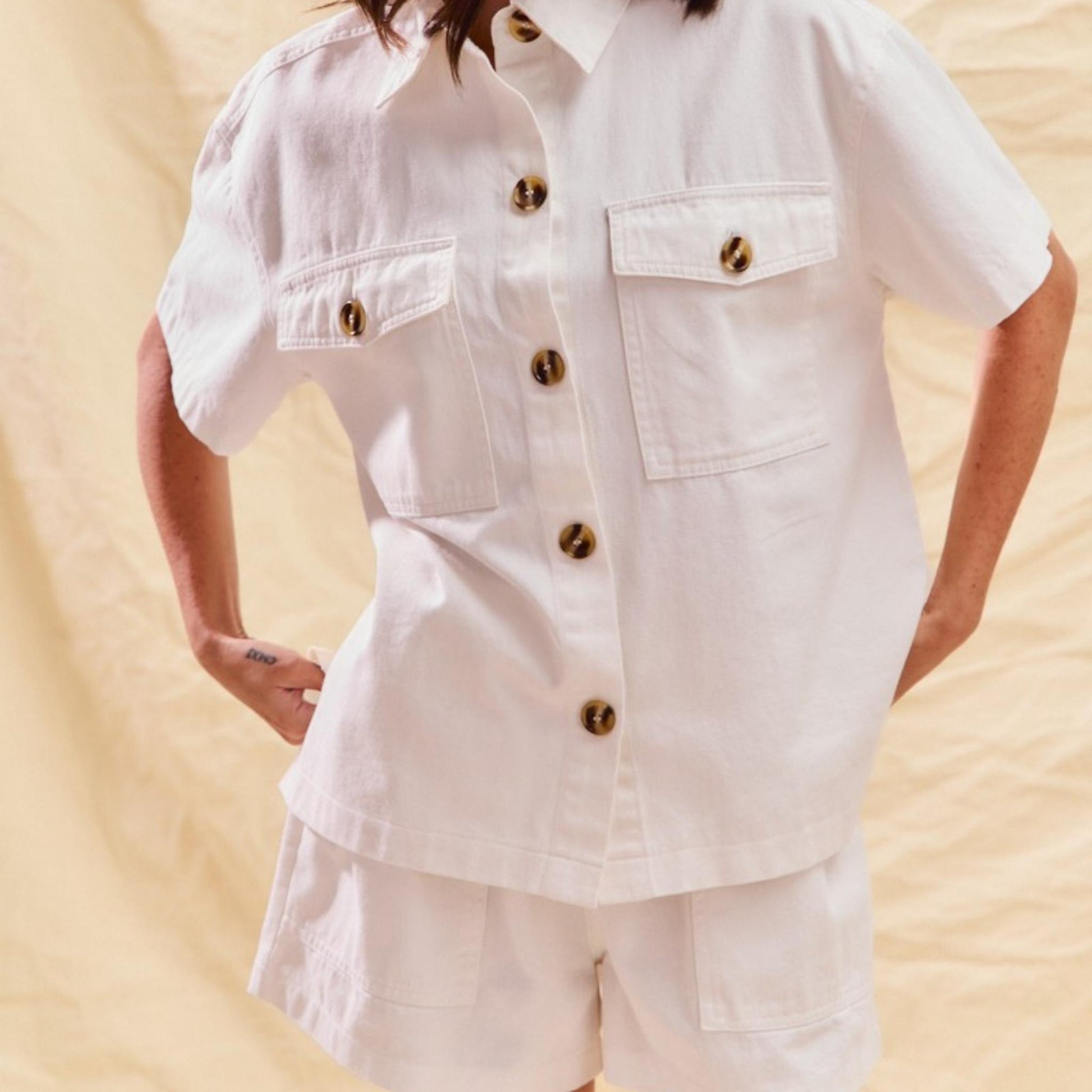 Lifestyle view of the SO ME denim two-piece set in off-white.