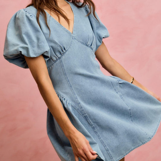 Close-up detail of the bubble sleeve design on the SO ME denim mini dress.