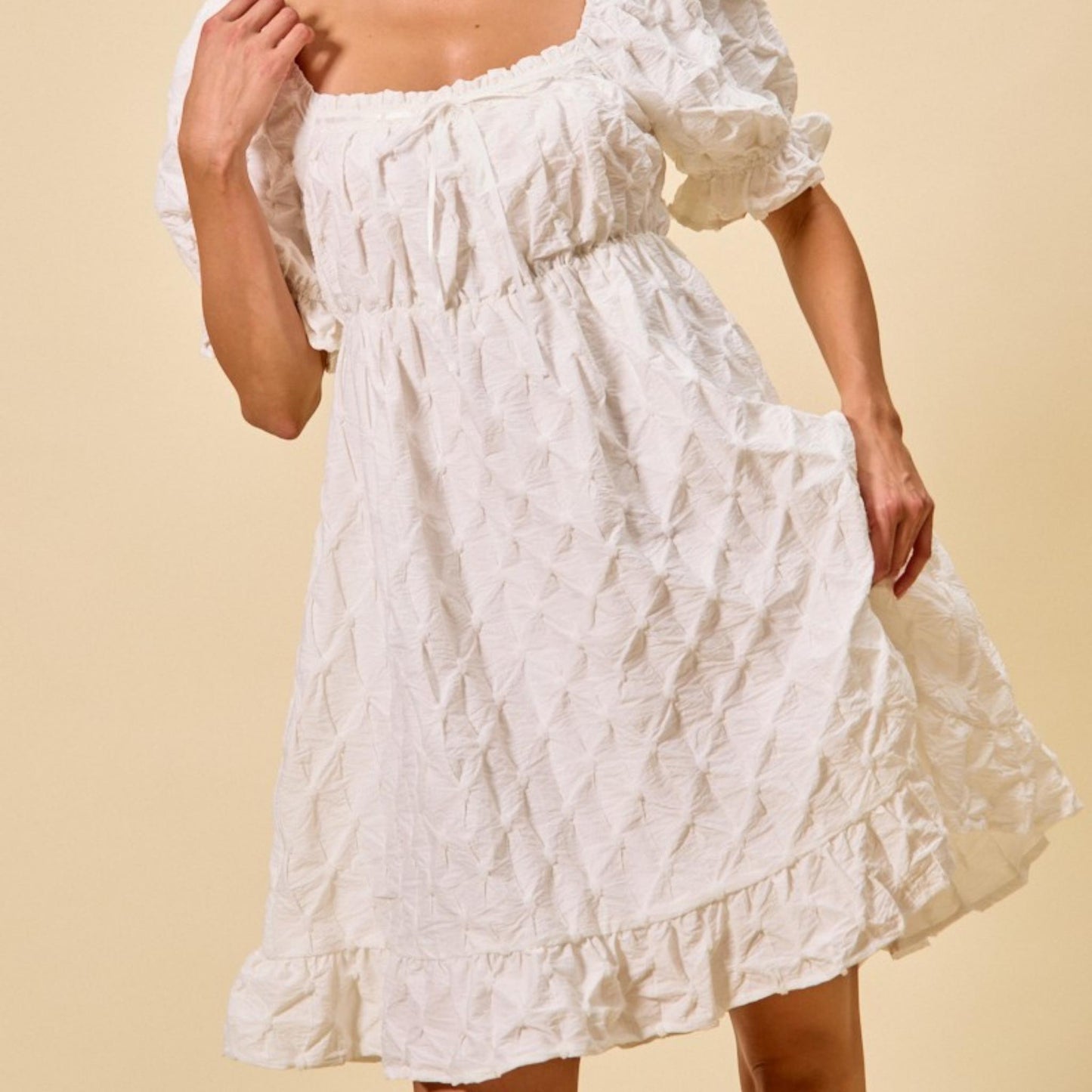 Close-up of the sophisticated ruching detail on the SO ME off white woven dress.