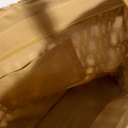 Close-up of a khaki jacket with a zipper and textured fabric.