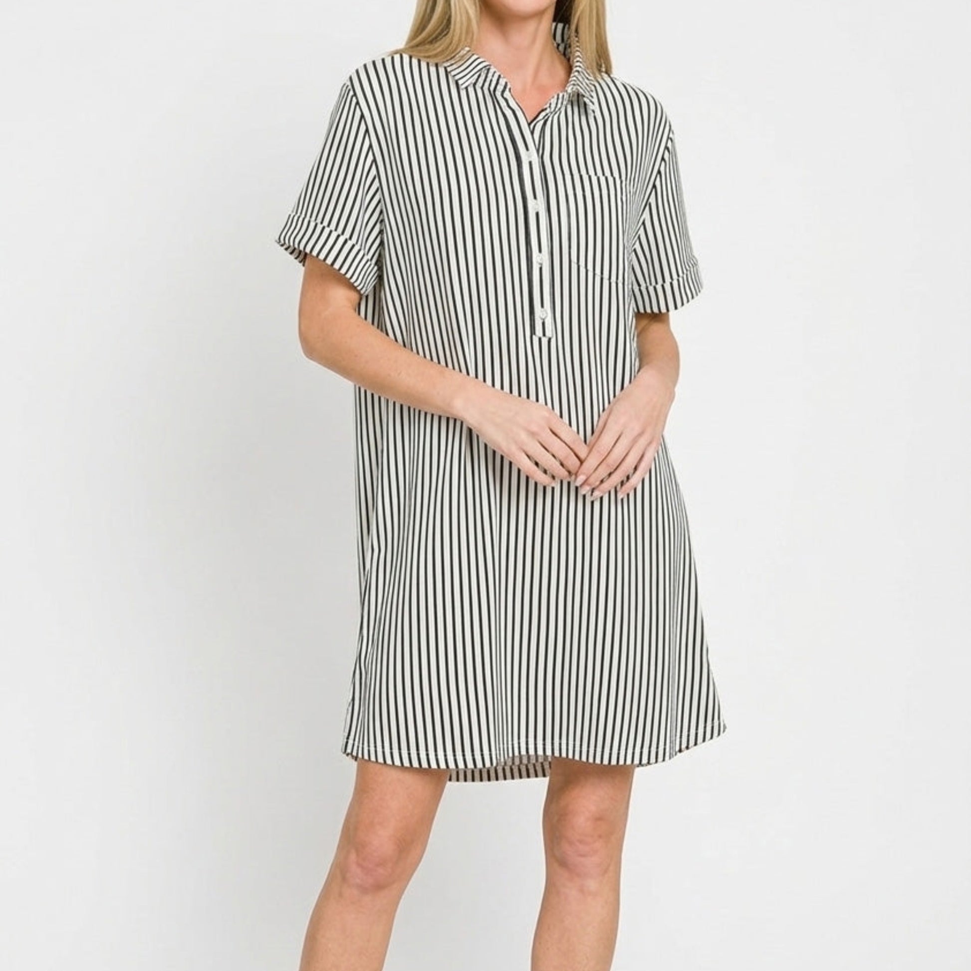 Close-up of the polished collar and half button-up detail on the black striped dress.