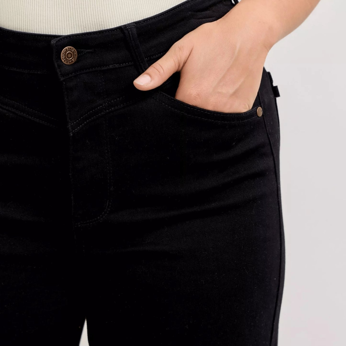 Detailed showcase of the premium cotton blend fabric on black wide-leg pants.