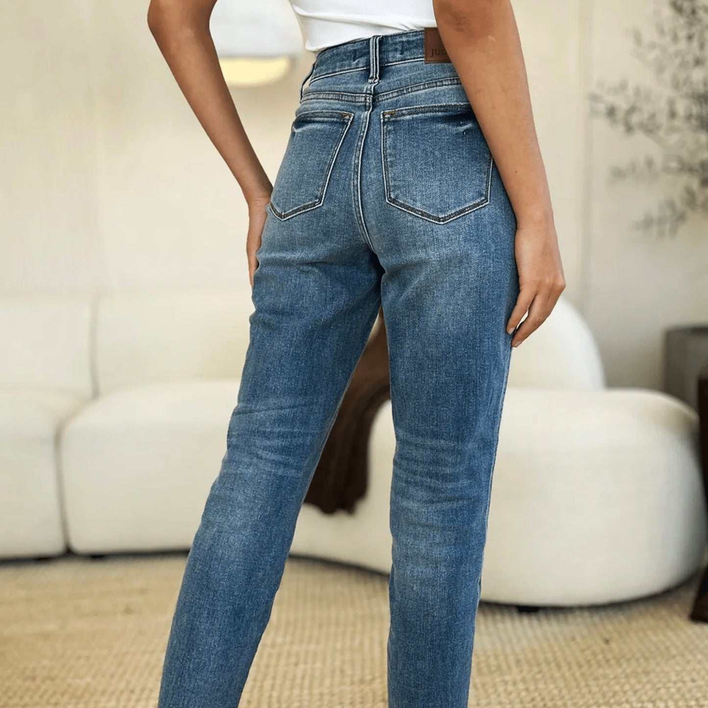 Back view of structured medium wash jeans showing the flattering fit and pockets.