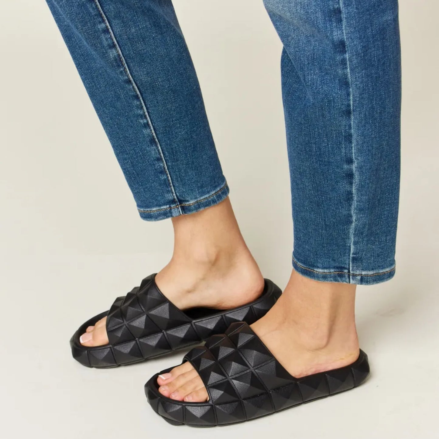 Side profile of black footbed sandals showing the 1.2-inch heel height.