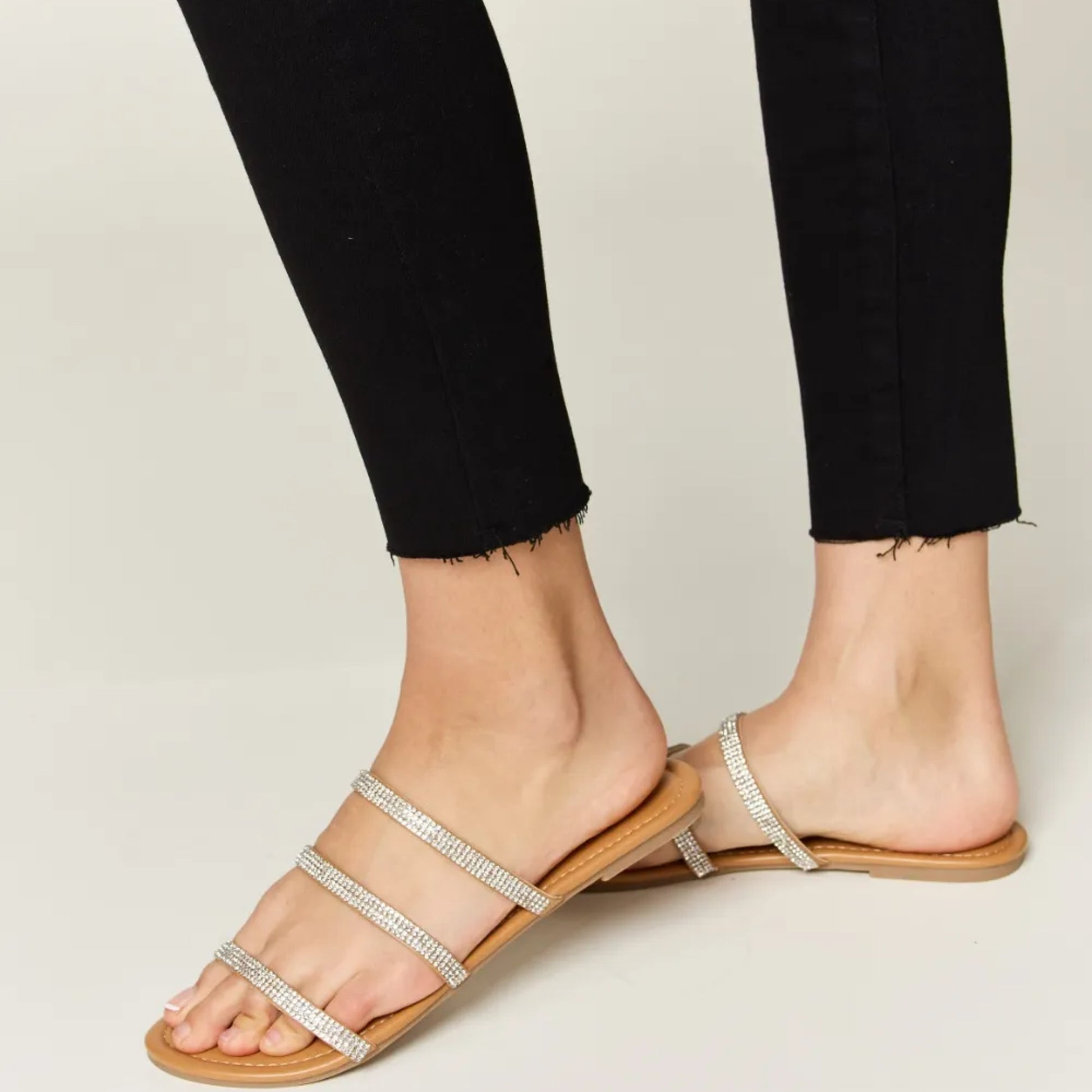 Side profile of tan flat sandals highlighting the 0.4-inch low heel.