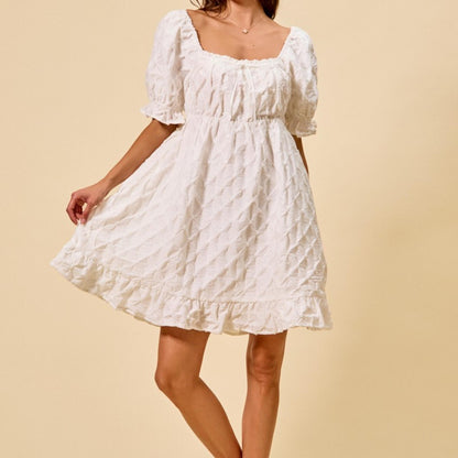 Side profile of the SO ME texture woven mini dress in off white.