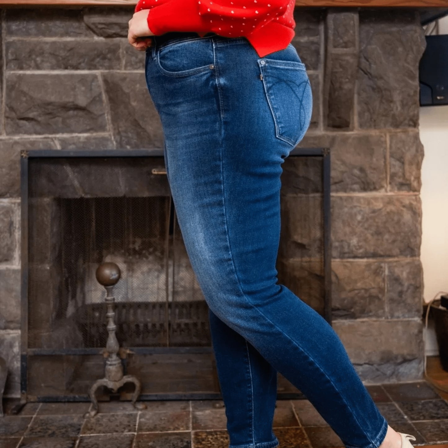 Side profile view of plus size thermal skinny jeans demonstrating the smooth, contoured silhouette.
