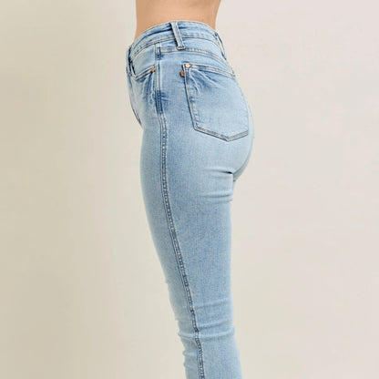 Side view of light blue skinny jeans highlighting the smoothing tummy control fit.