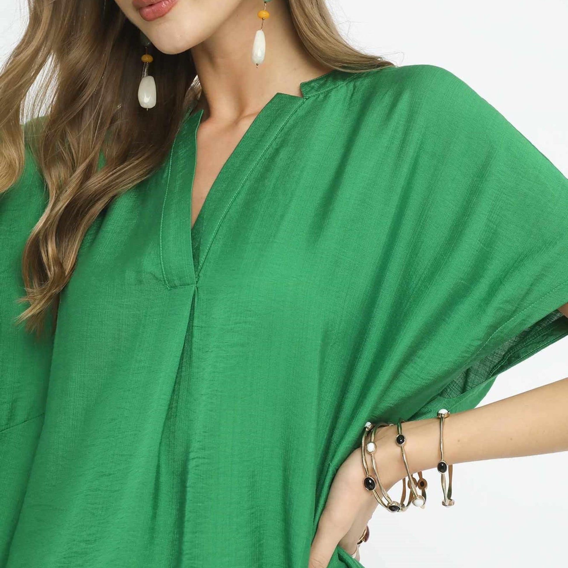 Close-up of the textured rayon fabric and classic V-neckline on the Umgee Apple Green blouse.