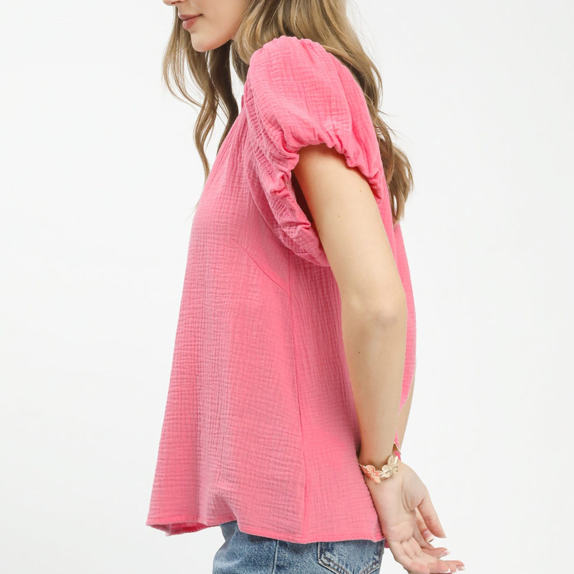 Side profile of the pink textured gauze top showing the relaxed, flowy fit.