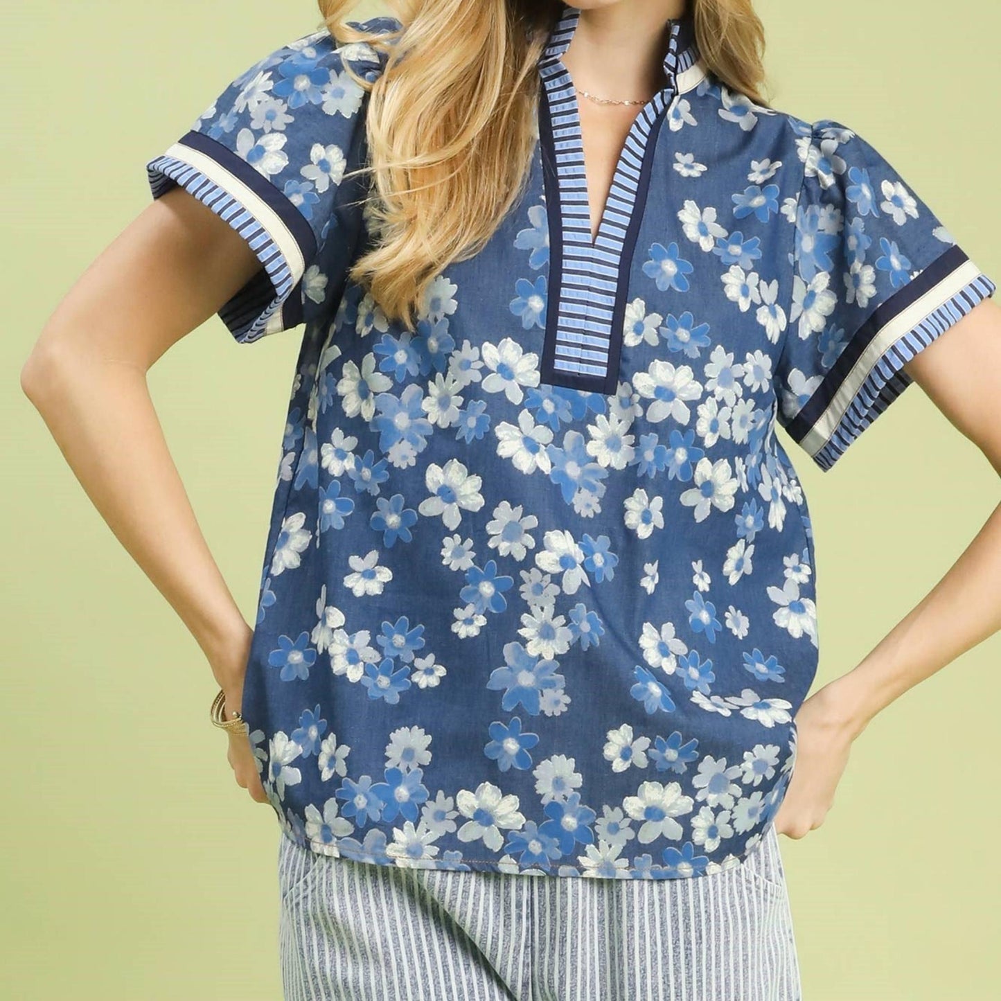 Front view of the Umgee mixed media print top featuring a colorful floral pattern on denim blue.