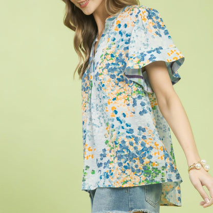 Side view highlighting the relaxed, airy fit of the Umgee mix media floral blouse.