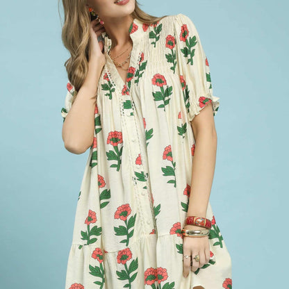 Front view of the Umgee floral print babydoll dress in Cream Mix featuring a tiered silhouette.