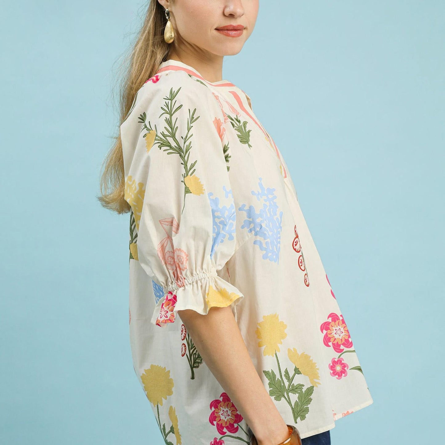 Full-length view of the Umgee floral split neck top showcasing the relaxed, flowy silhouette.