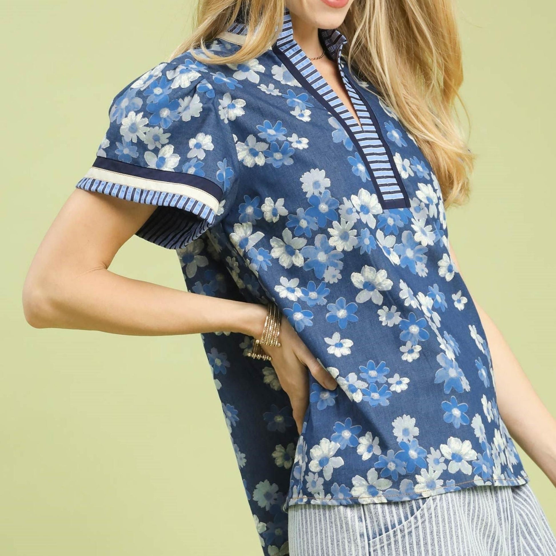 Side profile showing the contrasting floral and striped fabrics on the boho blouse.