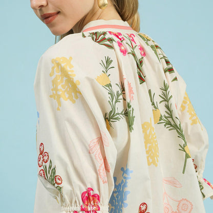Close-up of the elasticized puff sleeves and intricate floral pattern on the Umgee Cream top.