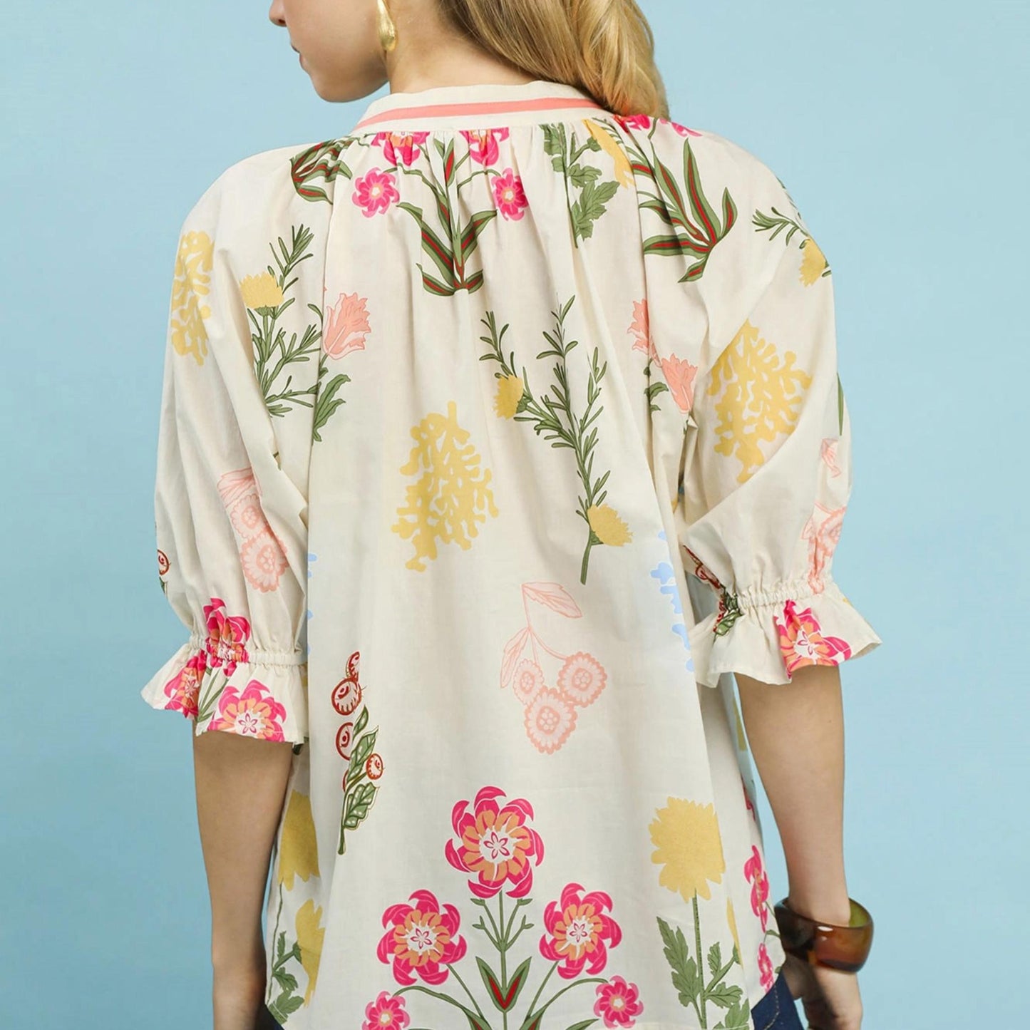 Detail view of the split neckline and adjustable ties on the Umgee floral print blouse.