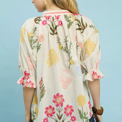 Detail view of the split neckline and adjustable ties on the Umgee floral print blouse.