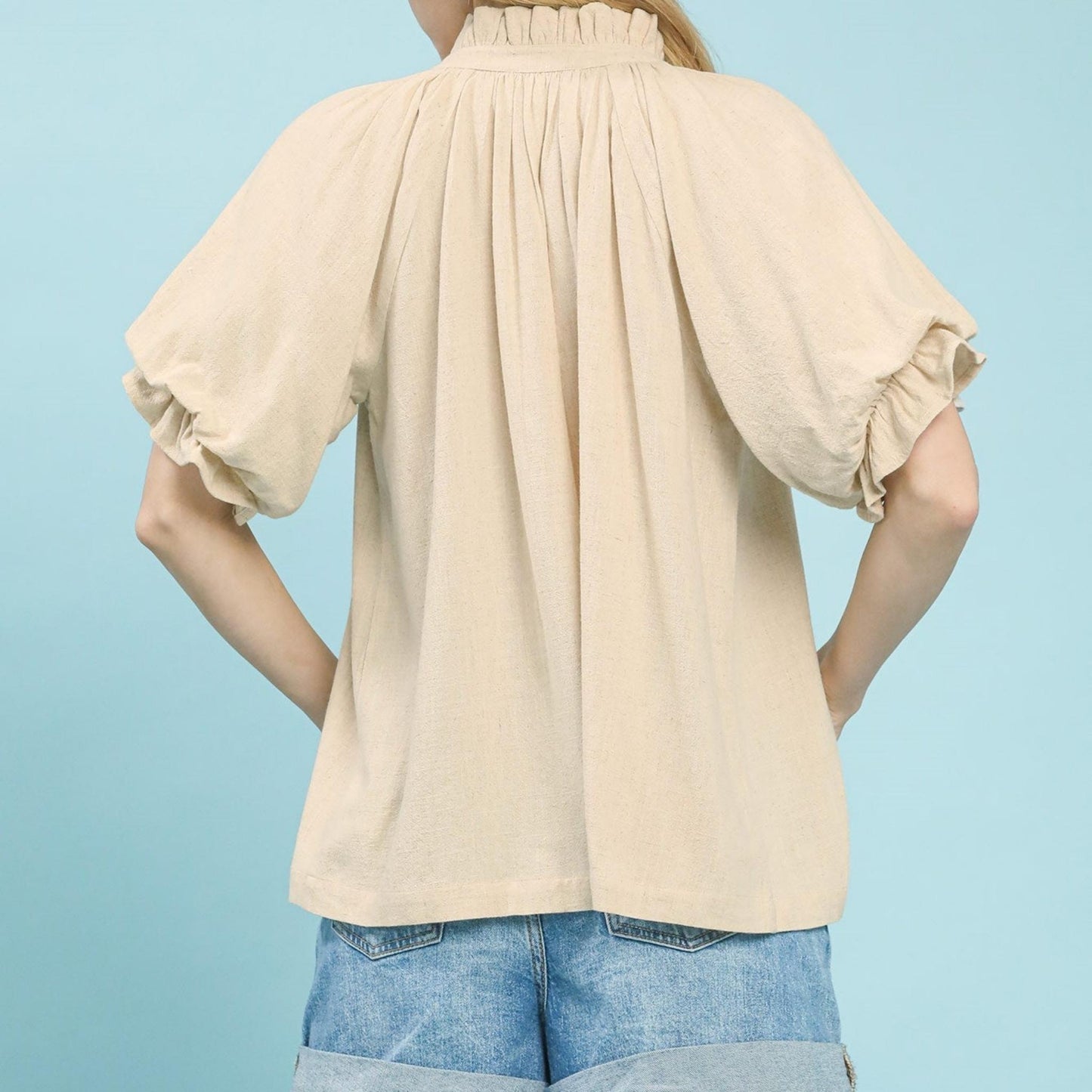 Back view of the women's oatmeal linen-cotton top highlighting the airy fabric.