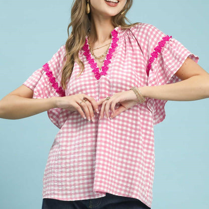 Front view of the Umgee Peony pink and white gingham top with lace trim.