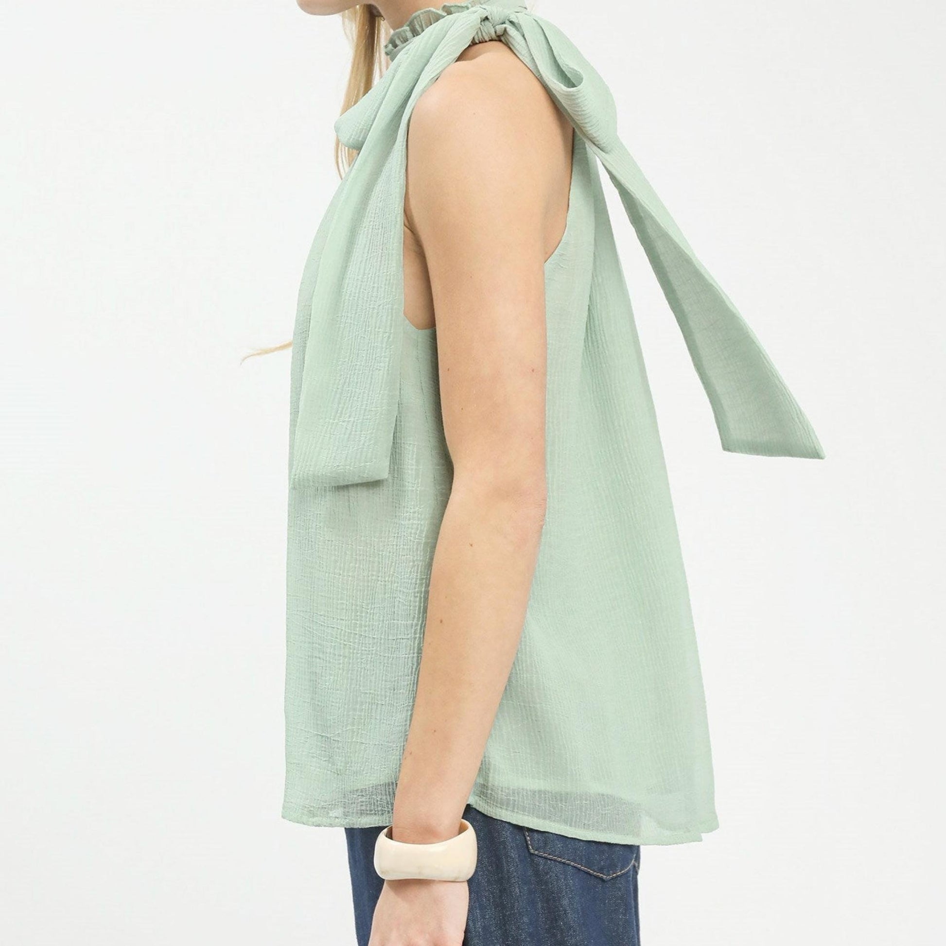 Side profile of the Umgee mint halter top showing the flowy, relaxed silhouette.