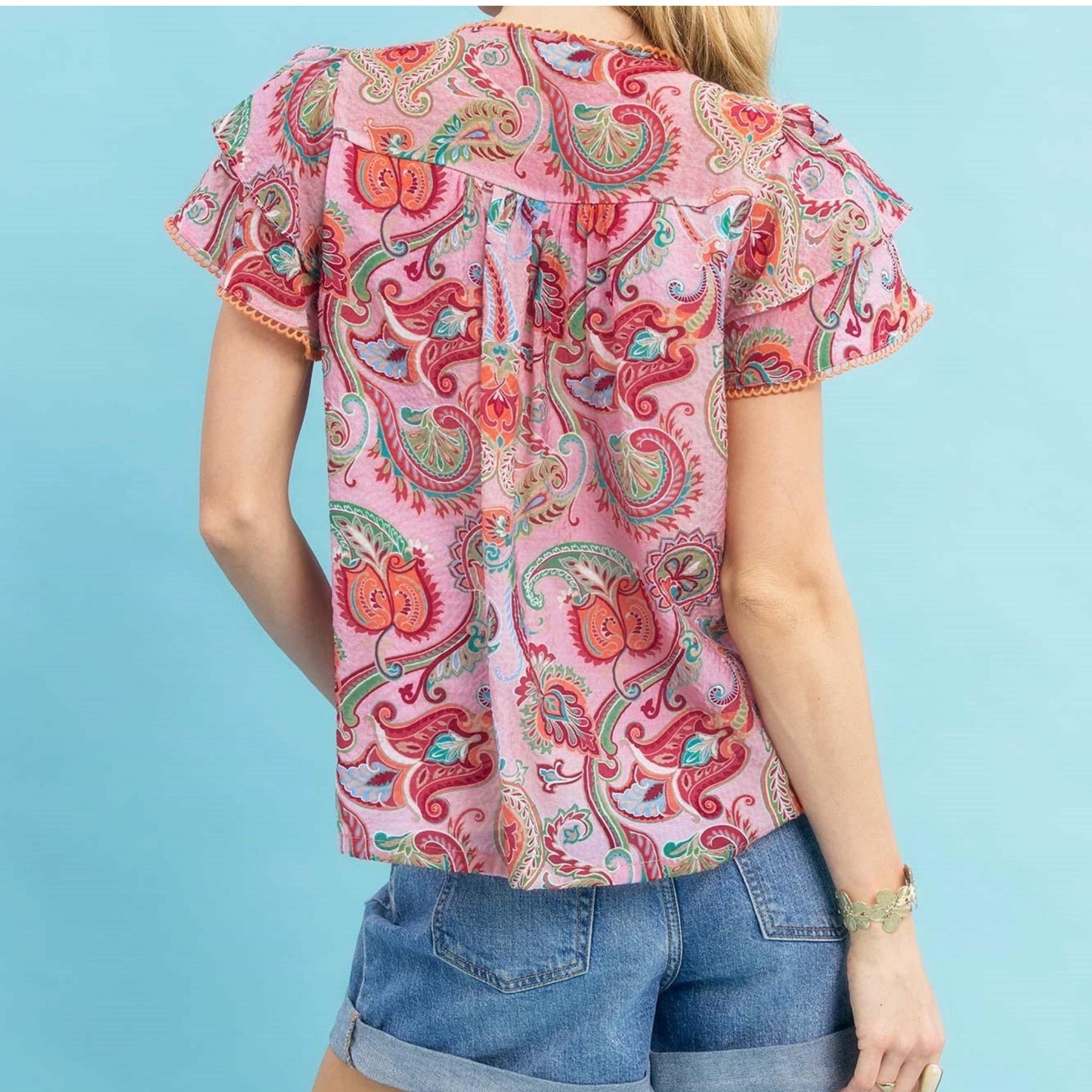 Back view showing the flowy silhouette and lightweight fabric of the mixed print top.