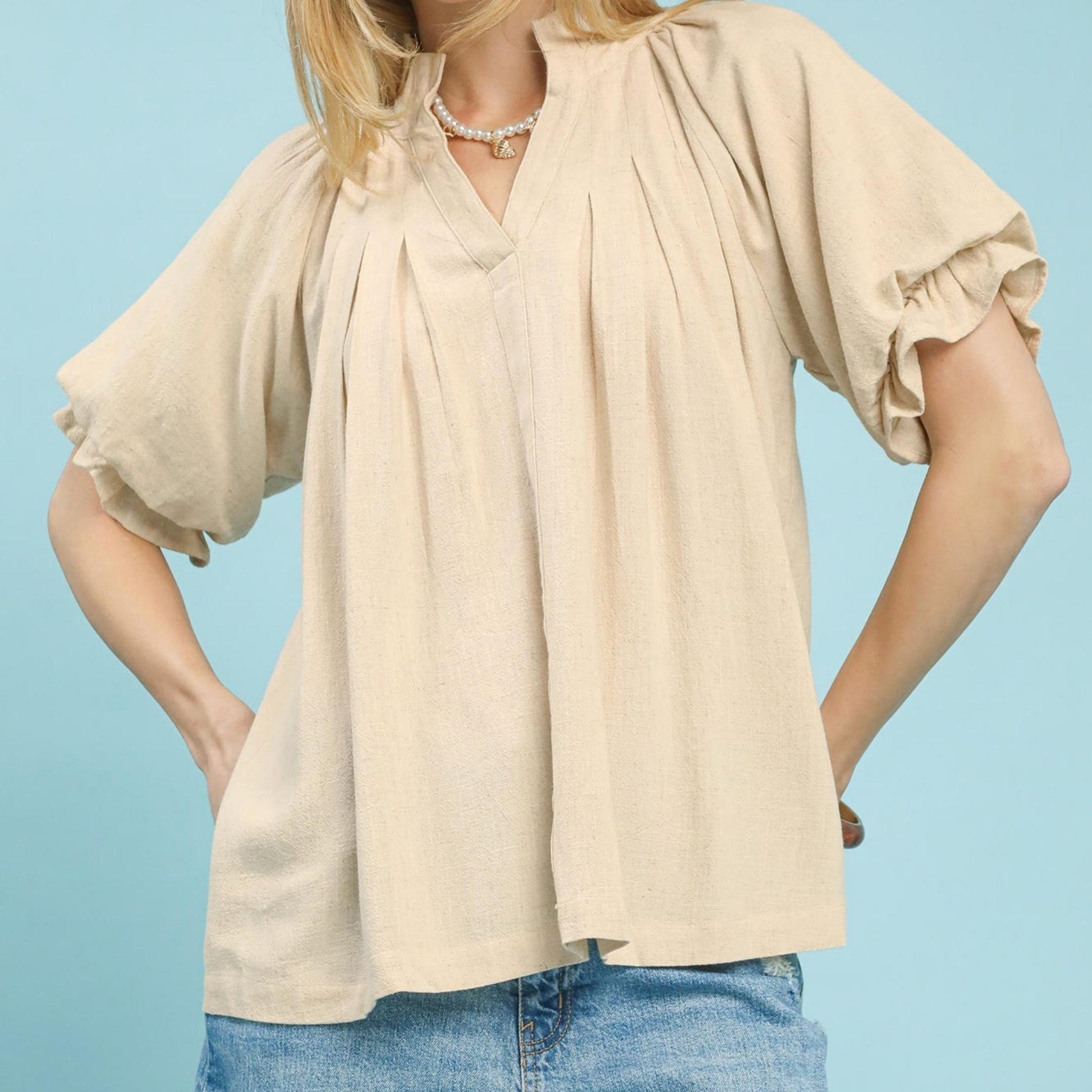 Front view of the Umgee oatmeal linen V-neck flutter sleeve top.