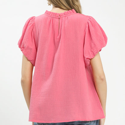 Back view of the pink cotton gauze top highlighting the airy and breathable material.