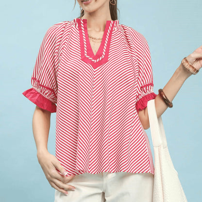 Front view of the Umgee stripe ruffle sleeve split-neck blouse in raspberry pink.