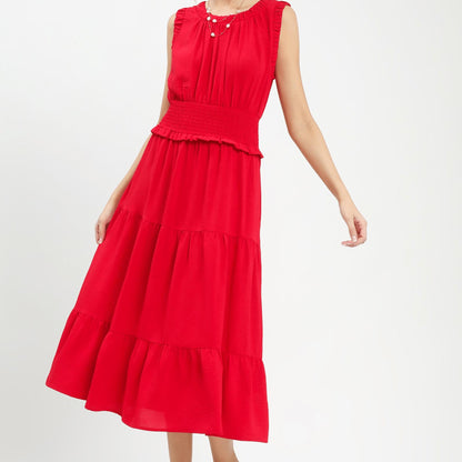 Lifestyle shot of the cherry red smocked dress styled for an outdoor summer event.