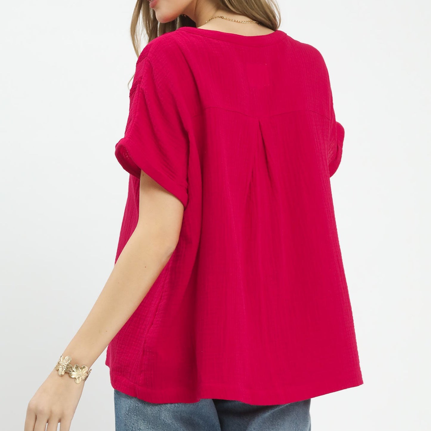 Back view of the red 100% cotton gauze blouse highlighting the soft, textured fabric.