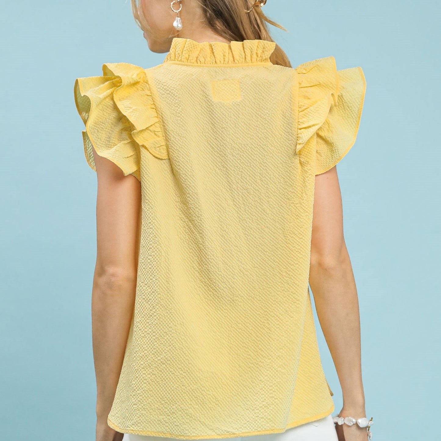 Back view of the women's romantic ruffle sleeve top in ice lemon.
