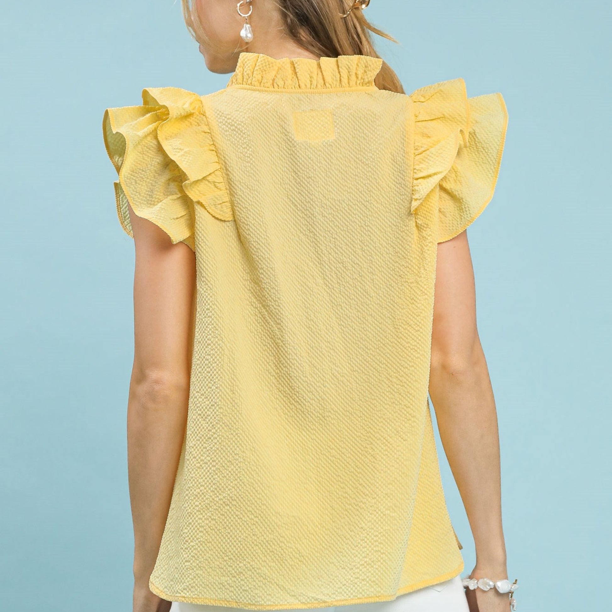 Back view of the women's romantic ruffle sleeve top in ice lemon.